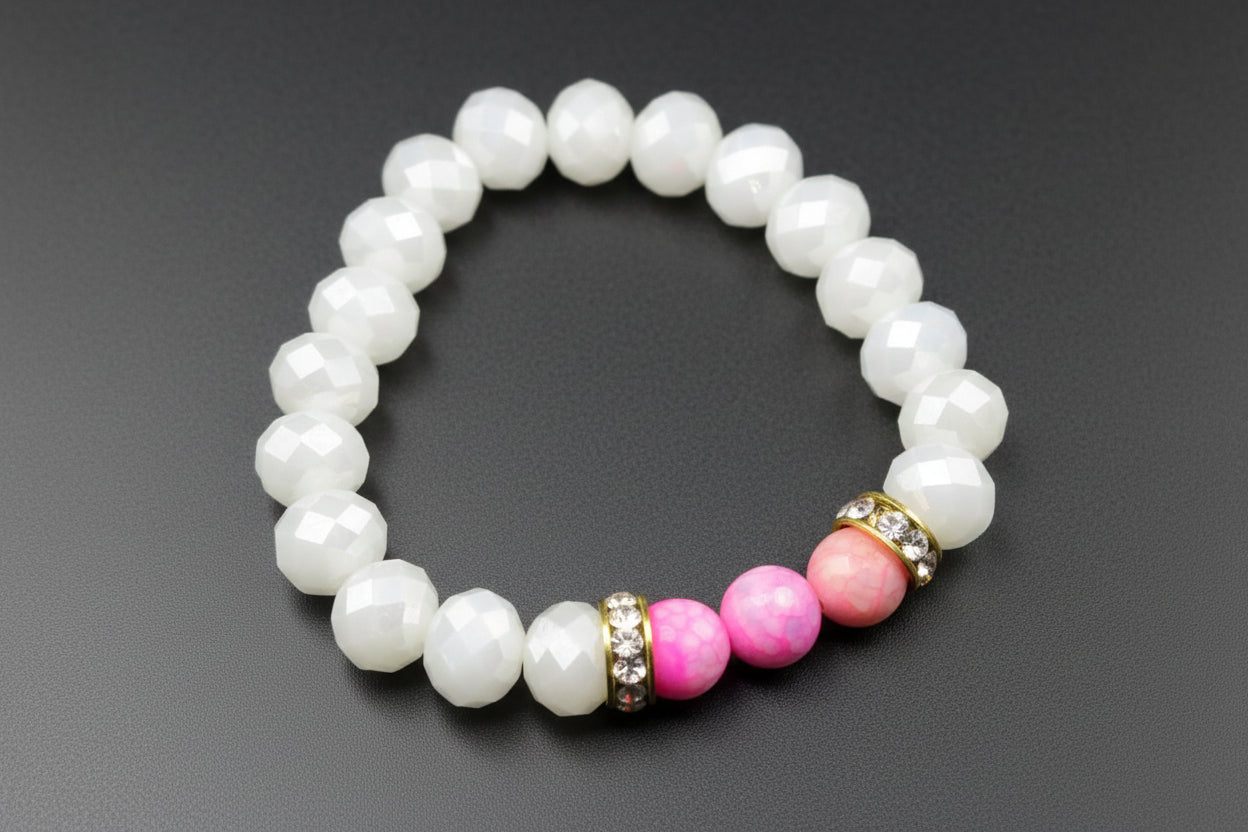 Pearl bracelet with pink and gold beads on a dark background