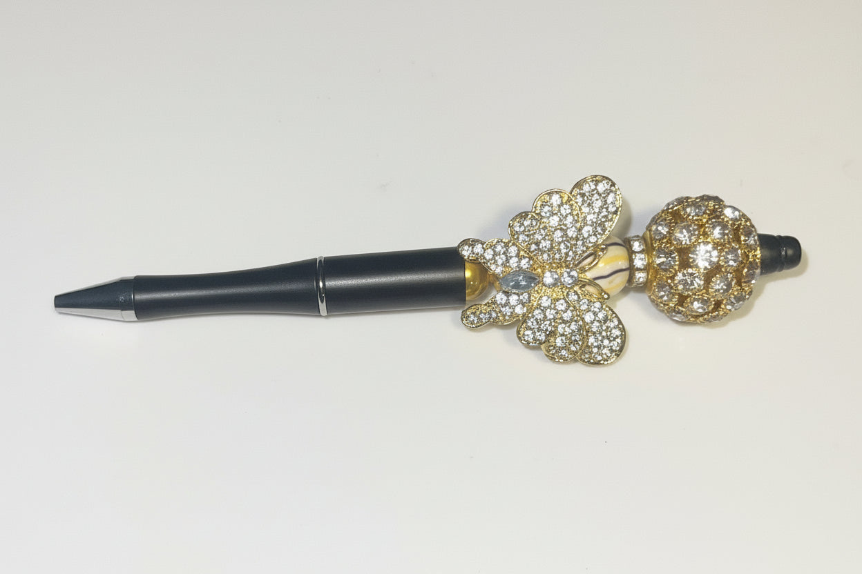 Handcrafted black pen with a large gold crystal butterfly charm by E-monae Jewels.