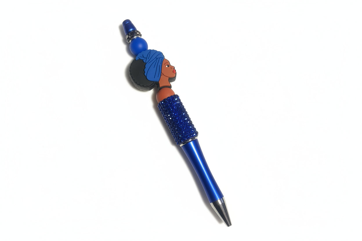 Wisdom, Heritage, and Strength. Blue pen with a woman in a blue headwrap charm by E-monae Jewels.