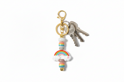 Gold keychain with rainbow and cloud design 