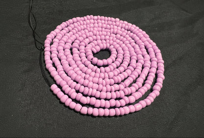 Purple beaded waist beads on a black background