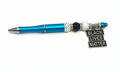 Handcrafted blue beaded pen with a silver Black Lives Matter charm by E-monae Jewels.
