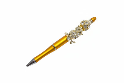 Handcrafted golden-orange beaded pen with a crystal owl charm by E-monae Jewels.