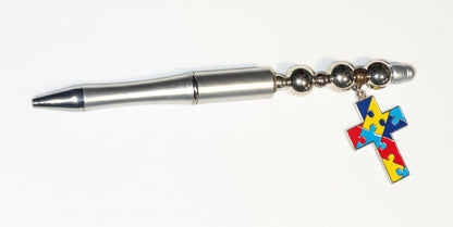 Handcrafted silver beaded pen with an Autism Awareness puzzle piece cross charm by E-monae Jewels.