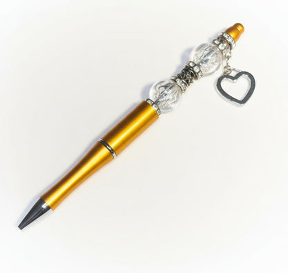 Handcrafted gold beaded pen with a sparkling gold heart charm and crystal accents by E-monae Jewels.