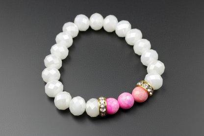 Pearl bracelet with pink and gold beads on a dark background
